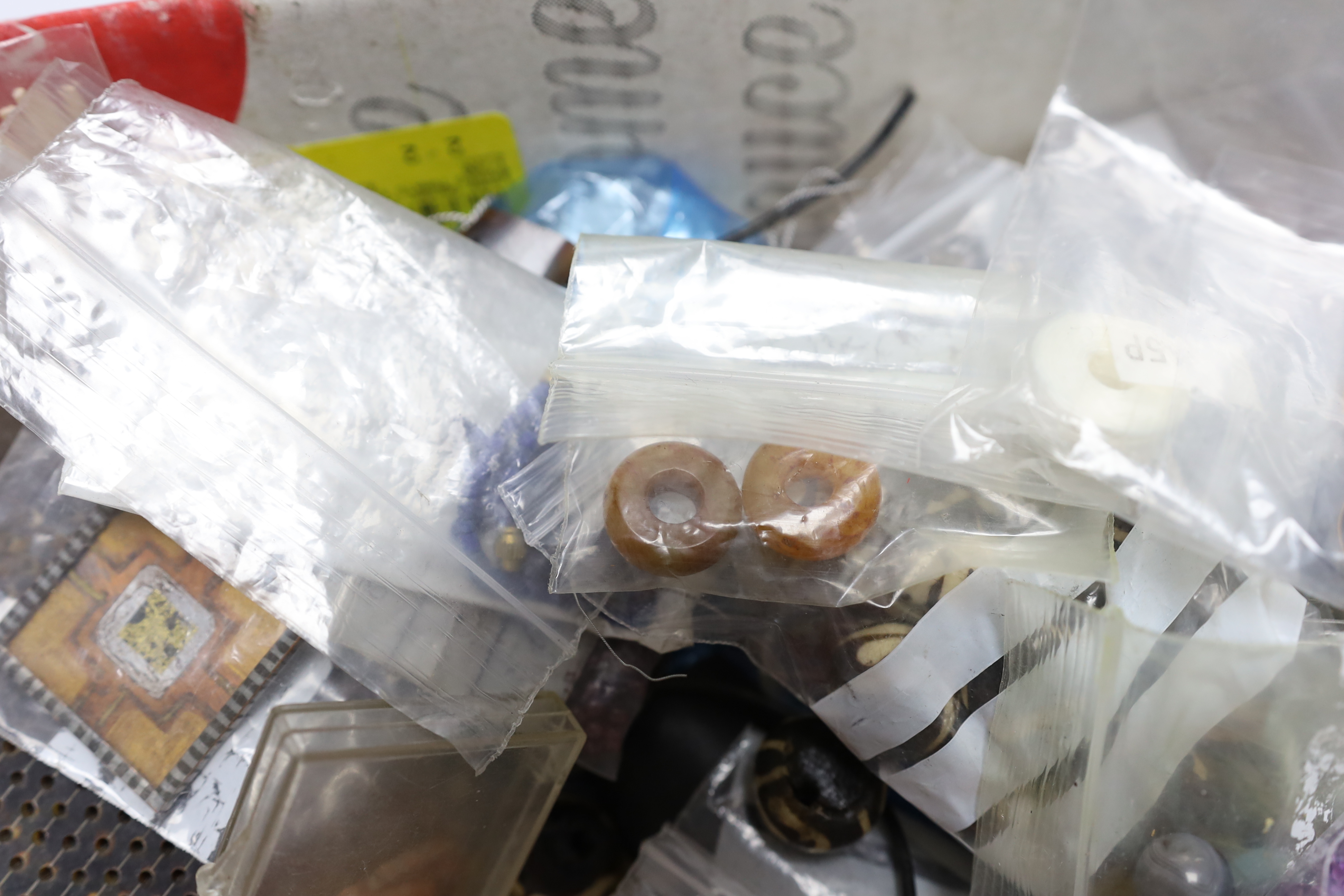 A quantity of assorted jewellery related items including loose beads, bolt rings, thread, copper wire, agate stones, etc.